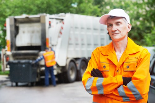 Construction site with builders handling waste clearance